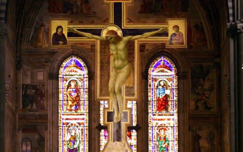 A 5.40-meter-high wooden crucifix painted by italian artist Giotto between 1288 and 1290 is seen on display in Florence's Santa Maria Novella church - Credit: AP/FABRIZIO GIOVANNOZZI