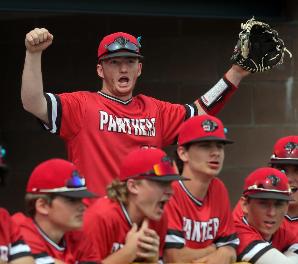 Norton third baseman Caleb Ogg cheers in the dugout during the sixth inning of a 5-2 win over Beachwood in a Division II district semifinal in North Ridgeville on Monday.