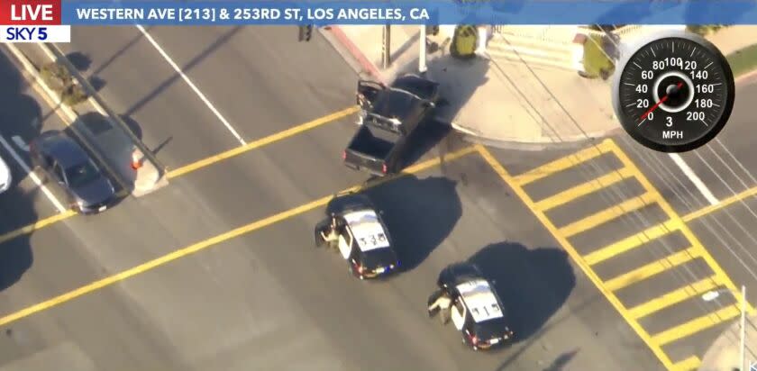 Law enforcement officials chase a suspect after a wild pursuit Friday afternoon in the streets of Los Angeles.(KTLA-TV)