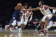 Brooklyn Nets guard Kyrie Irving (11) drives past Cleveland Cavaliers center Evan Mobley (4) during the second half of an NBA basketball game Friday April 8, 2022, in New York. (AP Photo/Bebeto Matthews)