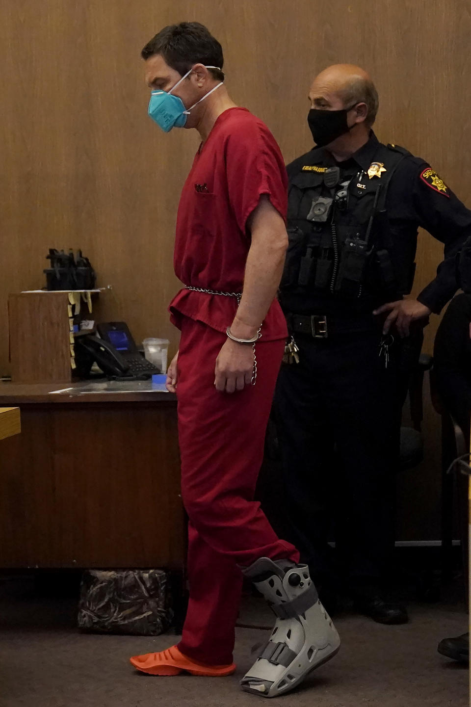 Scott Peterson, left, walks to his seat at the San Mateo County Superior Court in Redwood City, Calif., Thursday, Aug. 11, 2022. Peterson is in court for a hearing to determine whether he gets a new trial in the murder of his pregnant wife because of juror misconduct. (AP Photo/Jeff Chiu, Pool)