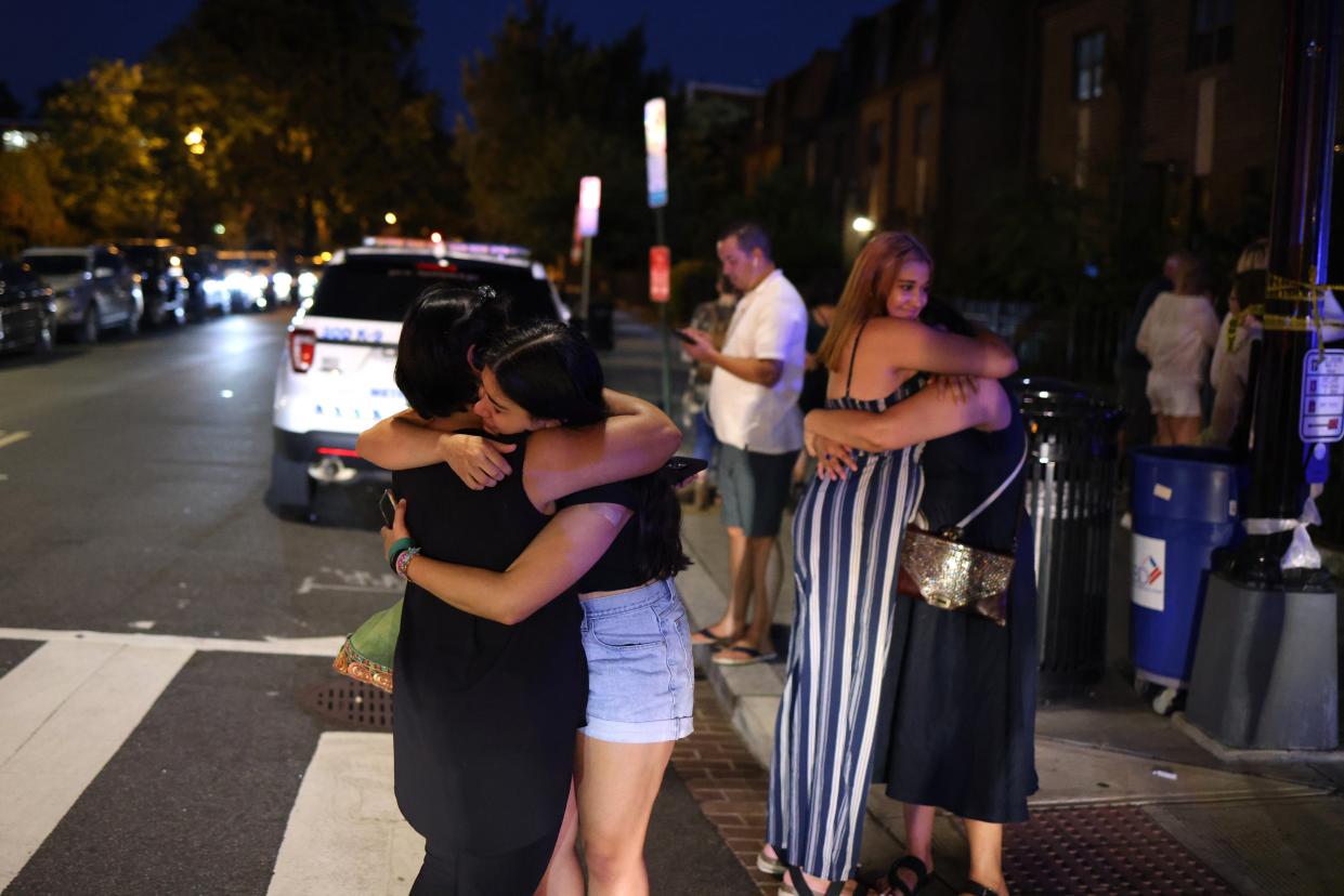 People embrace near the site of a shooting on July 22, 2021 in Washington, DC (Getty Images)