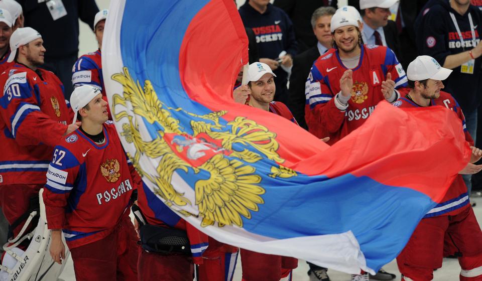 Russian team celebrates with a flag after a final game of the IIHF International Ice Hockey World Championship in Helsinki on May 20, 2012, as Team Russia defeated team Slovakia 6-2 . AFP PHOTO/ ALEXANDER NEMENOVALEXANDER NEMENOV/AFP/GettyImages