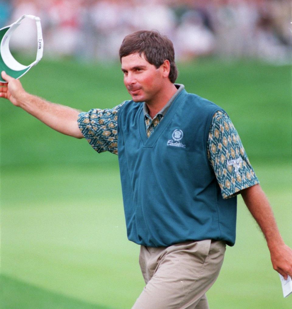 Fred Couples waves to fans at the TPC Sawgrass Players Stadium Course after winning the 1996 Players Championship.