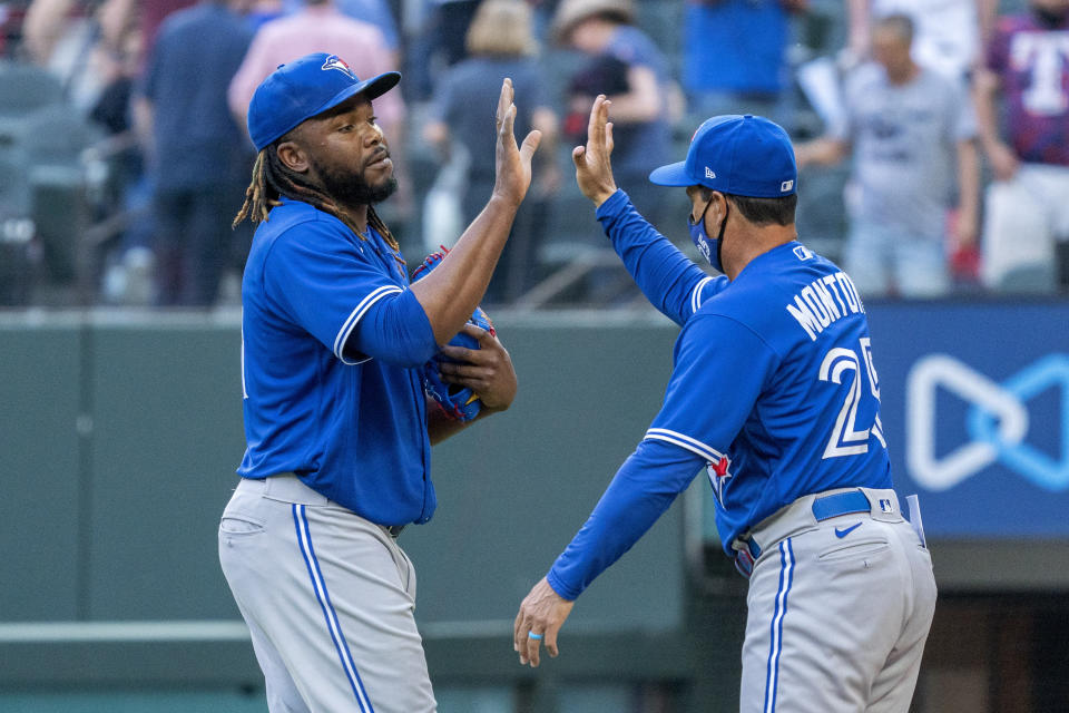 Toronto Blue Jays' Vladimir Guerrero Jr., left, and manager Charlie Montoya, right, celebrate their victory over the Texas Rangers in a baseball game Monday, April 5, 2021, in Arlington, Texas. (AP Photo/Jeffrey McWhorter)