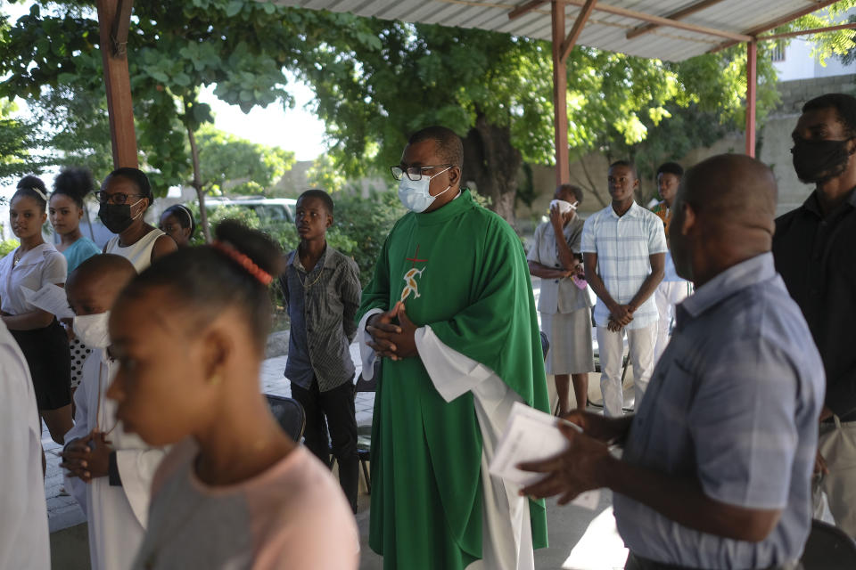 FILE - Catholic priest Jean-Nicaisse Milien walks to give a Mass in Port-au-Prince, Haiti, Sunday, Nov. 7, 2021. Father Milien was kidnapped for 20 days along with other priests, nuns, and civilians in April by the 400 Mawozo gang who have been holding 17 members of a U.S.-based missionary group Christian Aid Ministries for more than 3 weeks. (AP Photo/Matias Delacroix, File)