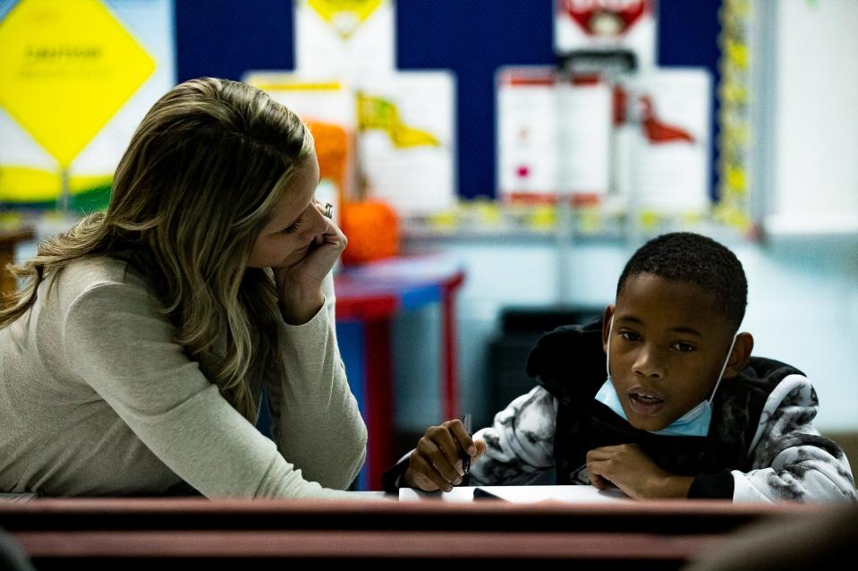 Amy Toncray, left, tutors a student while other educators observe behind a two-way mirror during a Reading Recovery teacher training session at Peaks Mill Elementary School in Frankfort, Kentucky.