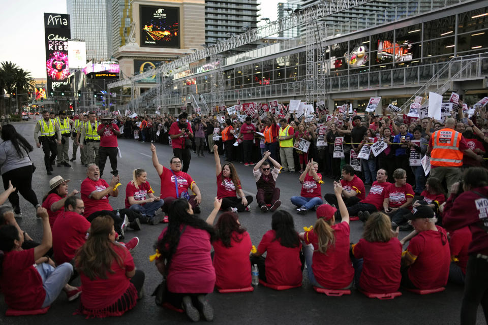 Police prepare to arrest members of the Culinary Workers Union along the Strip, Wednesday, Oct. 25, 2023, in Las Vegas. Thousands of hotel workers fighting for new union contracts rallied Wednesday night on the Las Vegas Strip, where rush-hour traffic was disrupted when some members blocked the road before being detained by police. (AP Photo/John Locher)