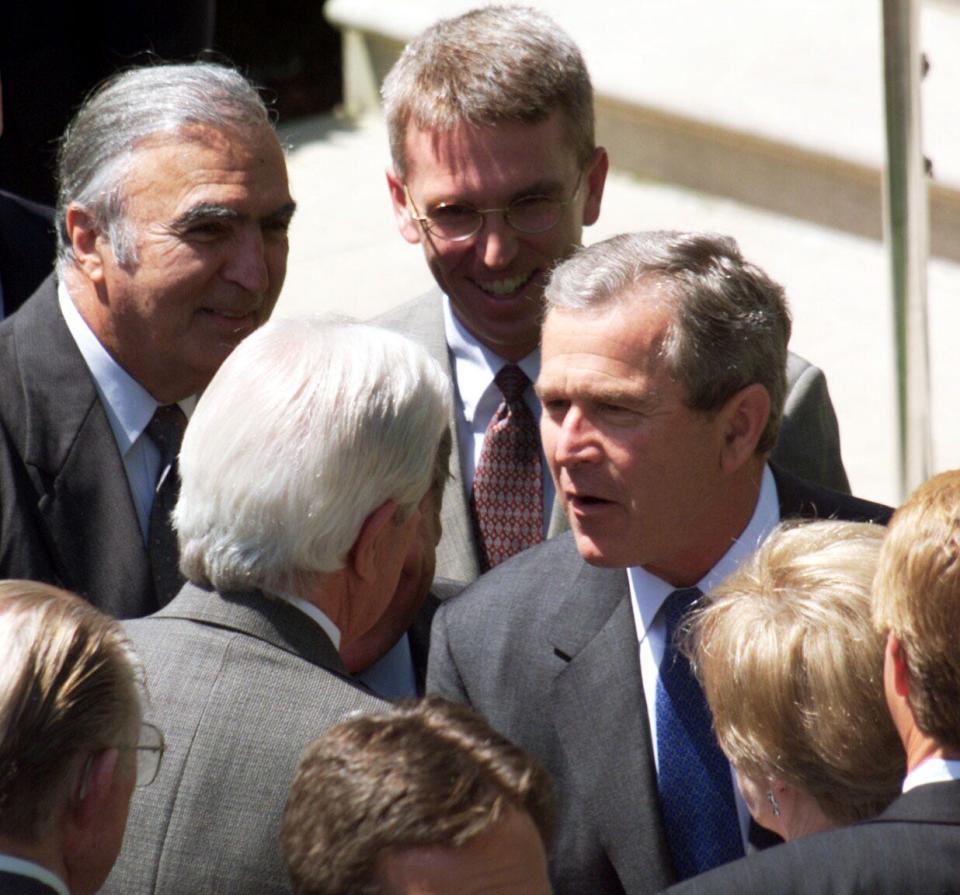 President George W. Bush chats with members of Congress at a pre-lunch reception to mark his 100th day in office in the Rose Garden of the White House on April 30, 2001