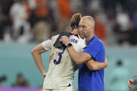 head coach Gregg Berhalter of the United States, right, hugs with Walker Zimmerman of the United States at the end of the World Cup round of 16 soccer match between the Netherlands and the United States, at the Khalifa International Stadium in Doha, Qatar, Saturday, Dec. 3, 2022. (AP Photo/Natacha Pisarenko)