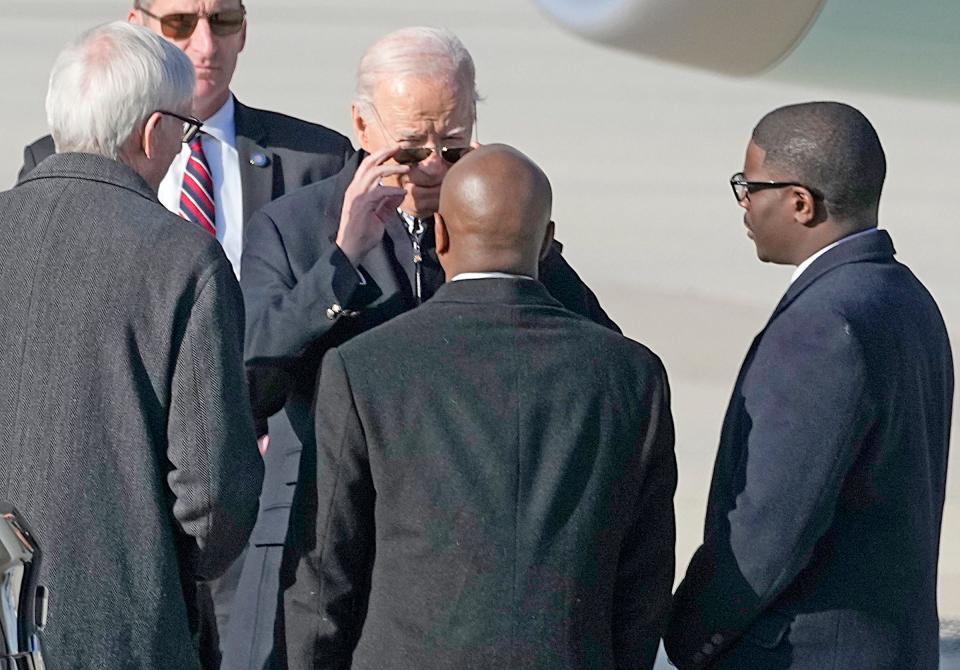 President Joe Biden (facing) greets Gov. Tony Evers (left), Milwaukee Mayor Cavalier Johnson, and Milwaukee County Executive David Crowley at Milwaukee Mitchell International Airport in Milwaukee on Wednesday, Dec. 20, 2023. President Biden will deliver remarks Wednesday at the Wisconsin Black Chamber of Commerce in Milwaukee centering on how his economic policies have led to recent business growth in underrepresented communities.