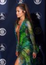 FILE - In this Feb. 23, 2000, file photo, singer Jennifer Lopez poses backstage at the 42nd Grammy Awards in Los Angeles. Michael Kors is buying the Italian fashion house Gianni Versace in a deal worth more than $2 billion (1.83 billion euros), continuing its hard charge into the world of high-end fashion. Versace is known for its Medusa-head logo and its flamboyant styles that are a fixture on Hollywood’s Red Carpet - like Lopez’s infamous dress worn to the Grammy Awards in 2000. (AP Photo/Reed Saxon, File)