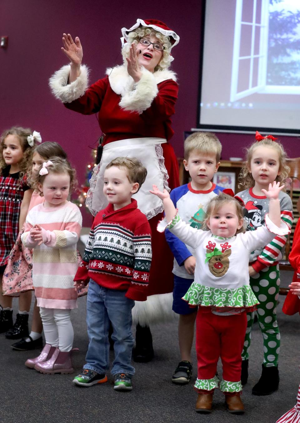 Mrs. Claus sings Christmas songs with some children during storytime at the Linebaugh Library in Murfreesboro on Dec. 7.