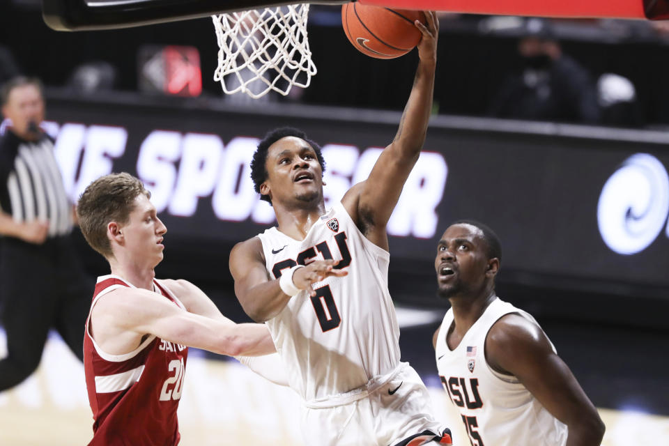 Oregon State's Gianni Hunt (0) makes it to the basket past Stanford's Noah Taitz (20) as teammate Dearon Tucker (35) looks on during the first half of an NCAA college basketball game in Corvallis, Ore., Monday, Jan. 4, 2021. (AP Photo/Amanda Loman)