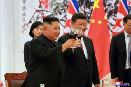 North Korean leader Kim Jong Un and Chinese President Xi Jinping raise a toast in Beijing, China, in this undated photo released June 20, 2018 by North Korea's Korean Central News Agency. KCNA via REUTERS