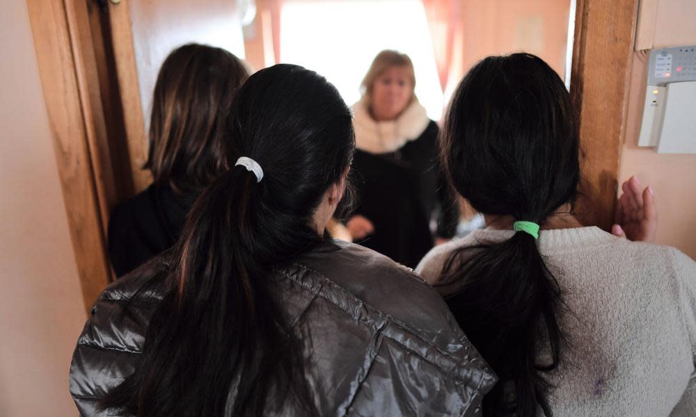 ROMANIA-CHILDREN-TRAFFICKING-CRIMEIana Matei (C), a Romanian psychologist who takes care of minors who have been victims of human trafficking talks with some of the girls there at the reception center near Pitesti city, southern Romania on January 27, 2017. At the reception center set up near Pitesti by the 