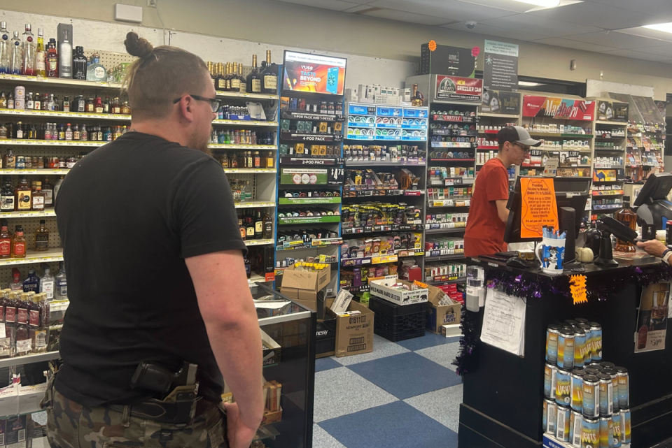 Steve Demele made a stop at the Roopers Beverage & Redemption carrying a gun in his holster (Andrea Blanco/The Independent)