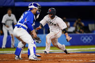 Japan's Takuya Kai scores past South Korea's Euiji Yang on a three run double by Japan's Tetsuto Yamada in the eight inning of a semi-final baseball game against South Korea at the 2020 Summer Olympics, Wednesday, Aug. 4, 2021, in Yokohama, Japan. (AP Photo/Matt Slocum)