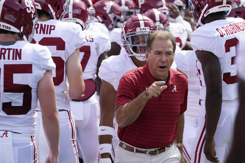 Alabama head coach Nick Saban, center, leads his team on the field during warm ups before an NCAA college football game against Florida, Saturday, Sept. 18, 2021, in Gainesville, Fla. (AP Photo/John Raoux)