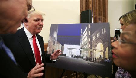 U.S. real-estate mogul Donald Trump gestures next to an architectural rendering of The Trump Organization's $200 million redevelopment of the iconic Old Post Office building into a luxury hotel, in Washington September 10, 2013. REUTERS/Kevin Lamarque