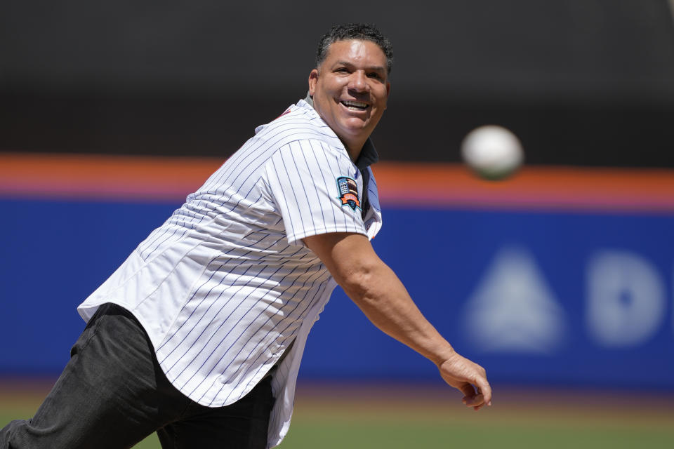 Former New York Mets pitcher Bartolo Colon throws the ceremonial first pitch before a baseball game against the Colorado Rockies, Sunday, May 7, 2023, in New York. (AP Photo/John Minchillo)