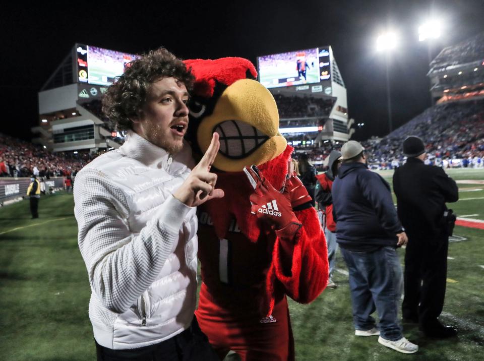 Rapper Jack Harlow greeted fans with high fives as he watched the Louisville-Kentucky game Saturday night. Nov. 27, 2021 