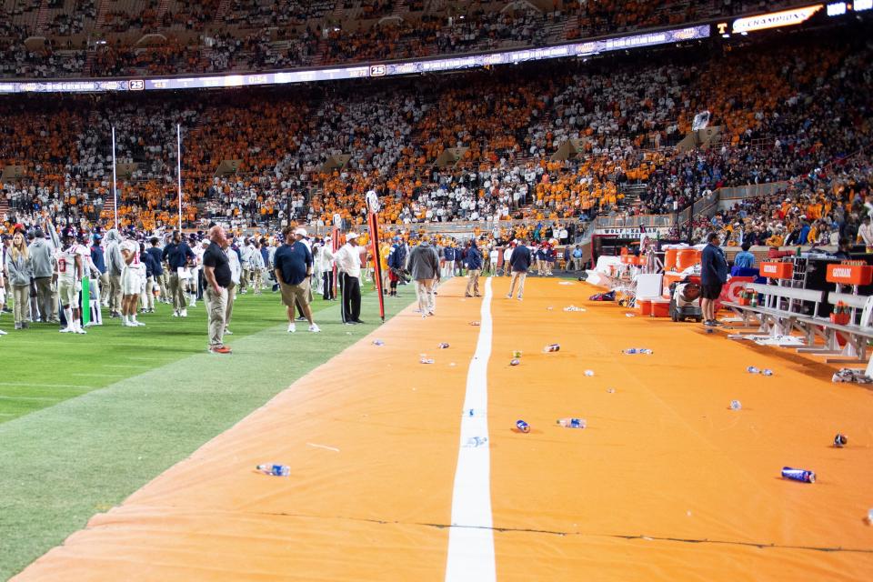 The Ole Miss bench is cleared while the game is paused due to Tennessee fans throwing trash on the field.