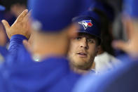 Toronto Blue Jays' Daulton Varsho celebrates in the dugout after hitting a two-run homer run during thesecond inning of a baseball game against the New York Yankees in Toronto, Wednesday, April 17, 2024. (Chris Young/The Canadian Press via AP)