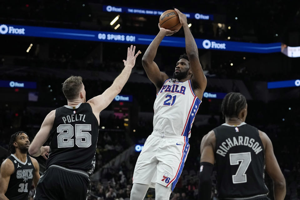 Philadelphia 76ers center Joel Embiid (21) shoots over San Antonio Spurs center Jakob Poeltl (25) during the first half of an NBA basketball game in San Antonio, Friday, Feb. 3, 2023. (AP Photo/Eric Gay)