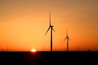 FILE PHOTO: Wind turbines operate at sunrise in Texas