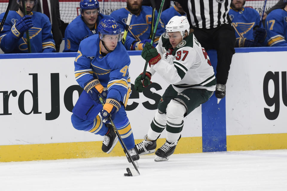 Minnesota Wild's Kirill Kaprizov (97) pressures St. Louis Blues' Torey Krug (47) during the third period of an NHL hockey game on Saturday, April 10, 2021, in St. Louis. (AP Photo/Joe Puetz)