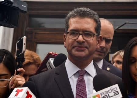 Pedro Pierluisi is surrounded by press during a special session of the Legislative Assembly in San Juan