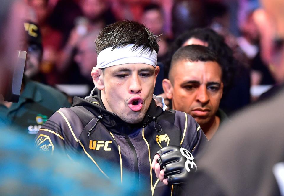 Jan 21, 2023; Rio de Janeiro, Brazil; Brandon Moreno (blue gloves) enters the arena before the fight against Deiveson Figueiredo (red gloves) during UFC 283 at Jeunesse Arena. Mandatory Credit: Jason da Silva-USA TODAY Sports