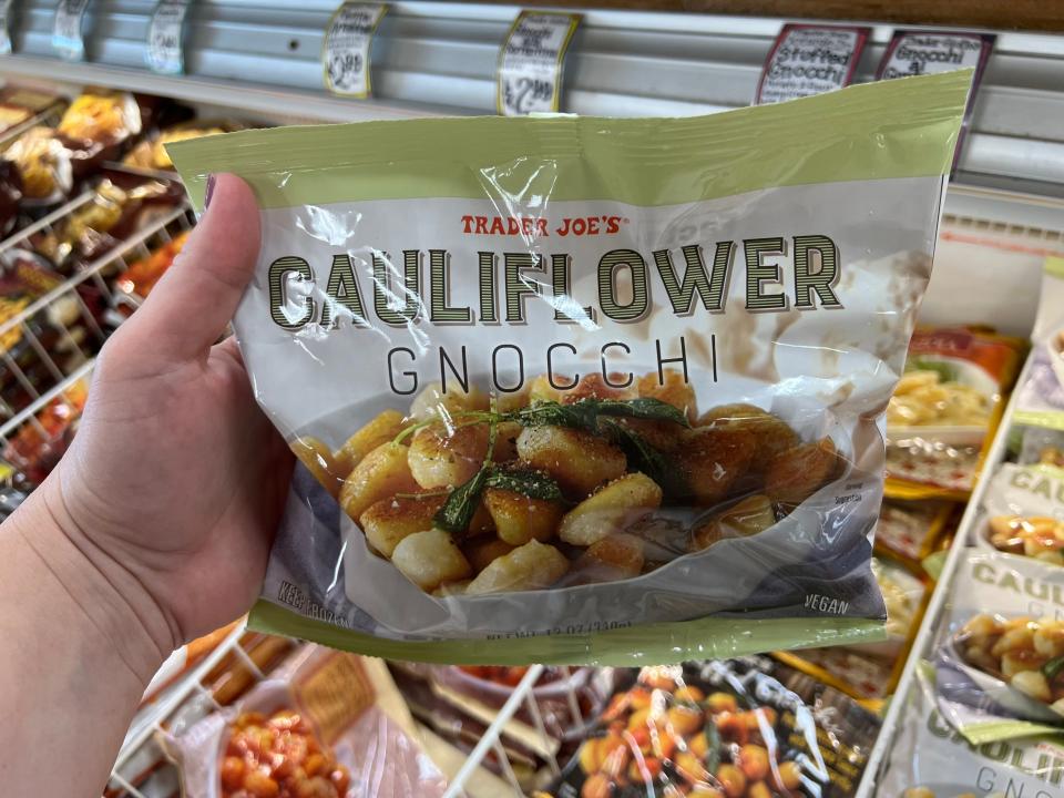 The writer holds a bag of cauliflower gnocchi