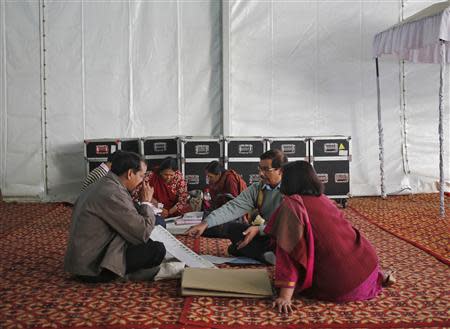 Polling officers sit inside an election training centre on the eve of the state election in New Delhi December 3, 2013. REUTERS/Anindito Mukherjee