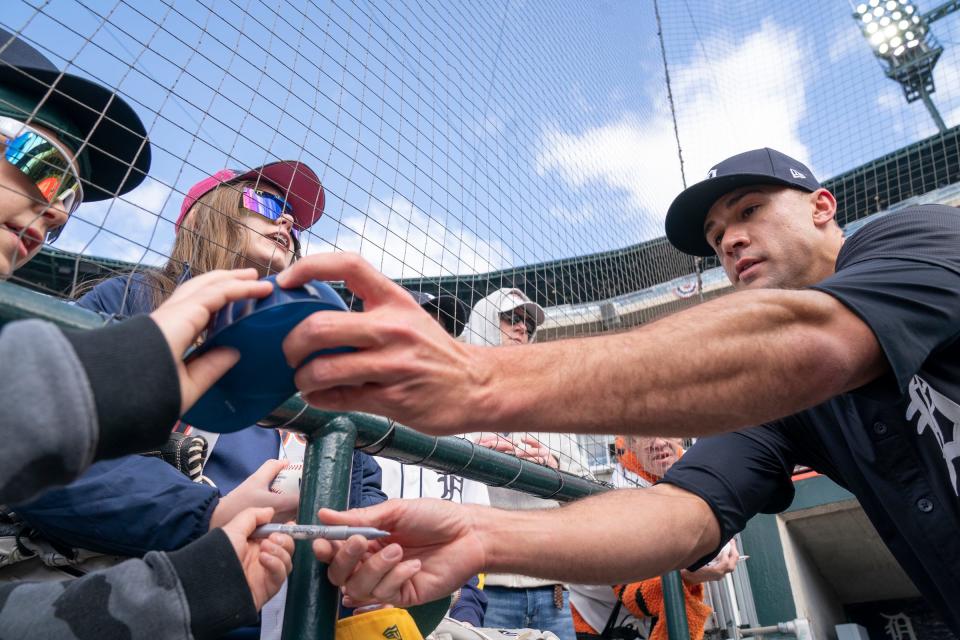 Liam Nyquist-Szarolta, 11, of Rochester, left, gets his souvenir Tigers hat signed by TigerÕs pitcher Jake Flaherty before the Detroit Tigers take on the Oakland Athletics for the Detroit home opener at Comerica Park on Friday, April 5, 2024.