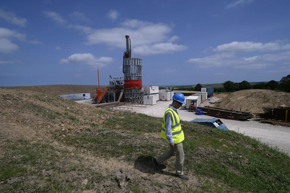 An employee walks down a hill at the Sirius Minerals test drilling station on the North Yorkshire Moors near Whitby, northern England July 5, 2013. Sirius Minerals, is planning one of the world's largest potash mines in response to booming global demand for the crop fertilizer, within the North York Moors National Park boundaries.  "There's a huge amount of paper work to deal with. Everyone's watching; there's pressure on both sides," operations director Graham Clarke told Reuters at the drill site near the coastal town of Whitby, where a large red rig pierces a clear summer sky. Photograph taken on July 5, 2013.  REUTERS/Nigel Roddis (BRITAIN - Tags: BUSINESS ENERGY ENVIRONMENT)