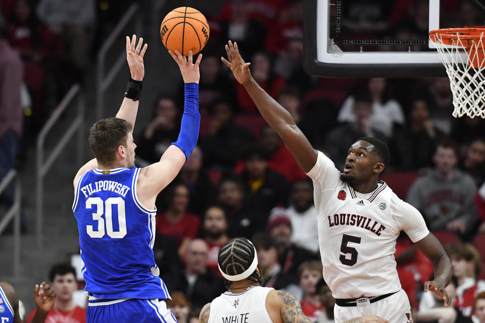 Louisville forward Brandon Huntley-Hatfield (5) attempts to block the shot of Duke center Kyle Filipowski (30) during the second half of an NCAA college basketball game in Louisville, Ky., Tuesday, Jan. 23, 2024. Duke won 83-69. (AP Photo/Timothy D. Easley)