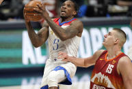 New Orleans Pelicans guard Eric Bledsoe (5) drives to the rim past Denver Nuggets center Nikola Jokic (15) in the second half of an NBA basketball game Wednesday, April 28, 2021, in Denver. (AP Photo/David Zalubowski)