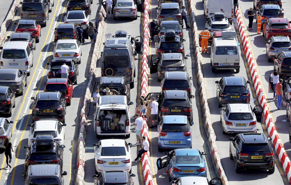 Passengers queue for ferries at the Port of Dover, during the hot weather, in Kent, England, Saturday July 16, 2022. (Gareth Fuller/PA via AP)