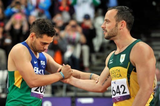 South Africa's Oscar Pistorius (R) shakes hands with Brazil's Alan Oliveira after losing to him in the Men's 200m T44 final at the London 2012 Paralympic Games on September 2. Pistorius has apologised for the timing of his outburst after the loss, in which he claimed it was not a fair race, but insisted there was an issue with large prosthetics lengthening an amputee's stride