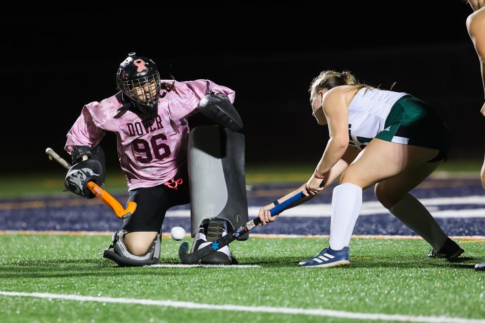 Dover goalie Hayley Tosh makes a save with help from Kaela Robins during Tuesday's Division I field hockey semifinal.