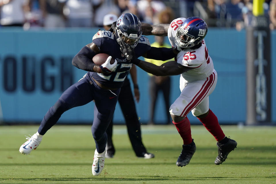 New York Giants linebacker Jihad Ward (55) tackles Tennessee Titans running back Derrick Henry (22) during the first half of an NFL football game Sunday, Sept. 11, 2022, in Nashville. (AP Photo/Mark Humphrey)