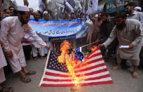 <p>Supporters of banned Islamic charity Jamatud Dawa burn a mock U.S. flag during a protest against drone strike in Peshawar, Pakistan, on May 27, 2016. A U.S. drone strike killed Mullah Mansoor in Balochistan province of Pakistan on May 21. Mullah Akhtar Mansoor took over the command of Taliban after the reports of Taliban’s supreme leader Mullah Omar’s death. (Arshad Arbab/EPA) </p>