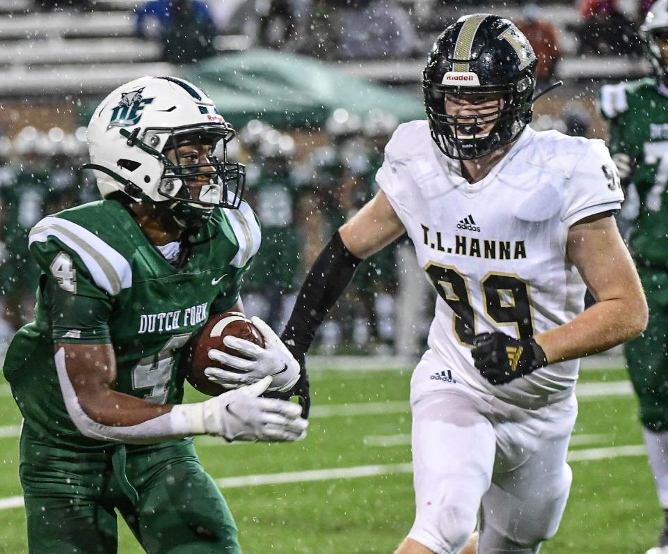 Dutch Fork receiver Jarvis Green runs near T.L. Hanna junior Jay Cheek(99) during the first quarter of the Class AAAAA State championship at Benedict College in Columbia, S.C. Friday, December 4, 2020.