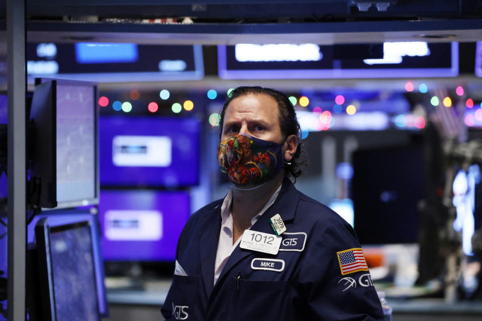 A trader works on the trading floor at the New York Stock Exchange (NYSE) in Manhattan, New York City, U.S., December 28, 2021. REUTERS/Andrew Kelly