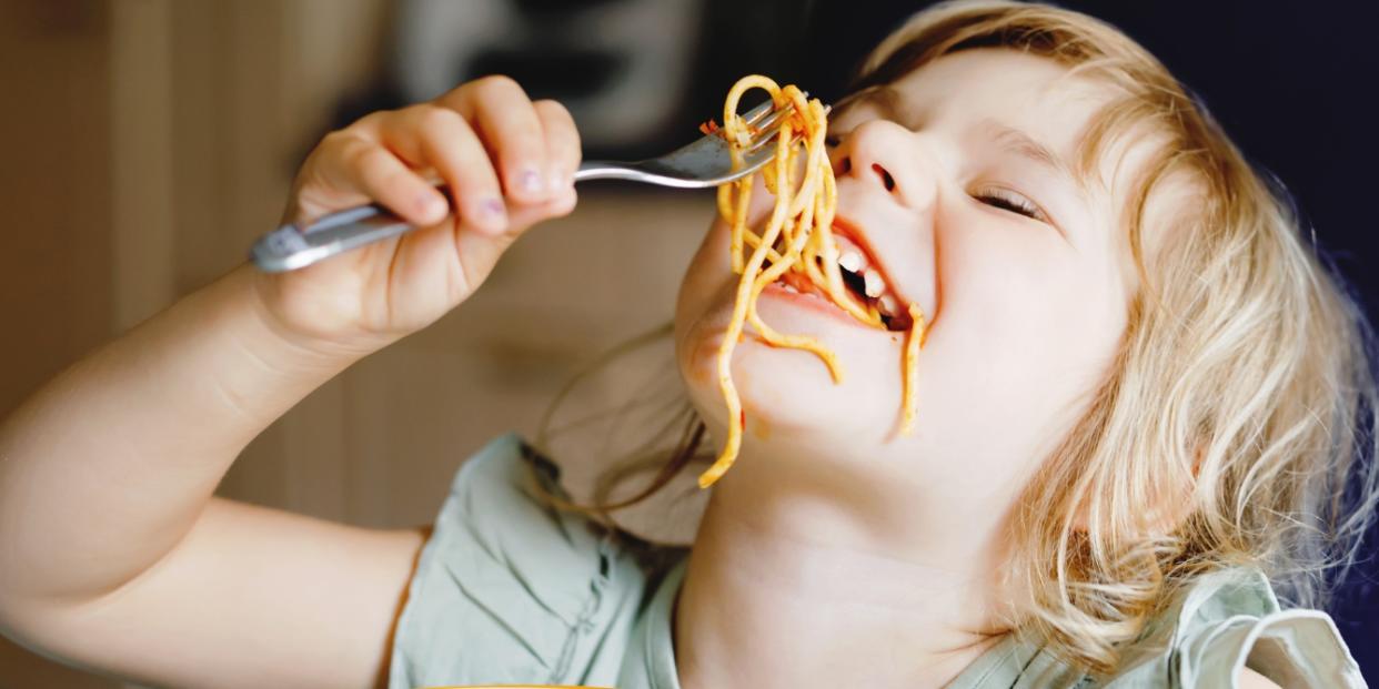 child eating spaghetti messily no rules dinner