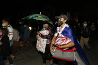 Migrants trying to reach the U.S. border walk before dawn along the highway leading to Choloma, Honduras, Thursday, Jan. 14, 2021. About 200 Honduran migrants resumed walking toward the border with Guatemala early Thursday, a day before a migrant caravan was scheduled to depart San Pedro Sula. (AP Photo/Delmer Martinez)