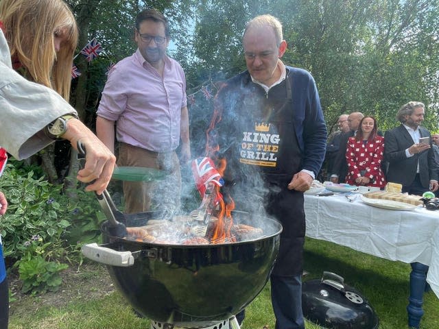 Liberal Democrat leader Sir Ed Davey, flipping burgers in a back garden barbecue