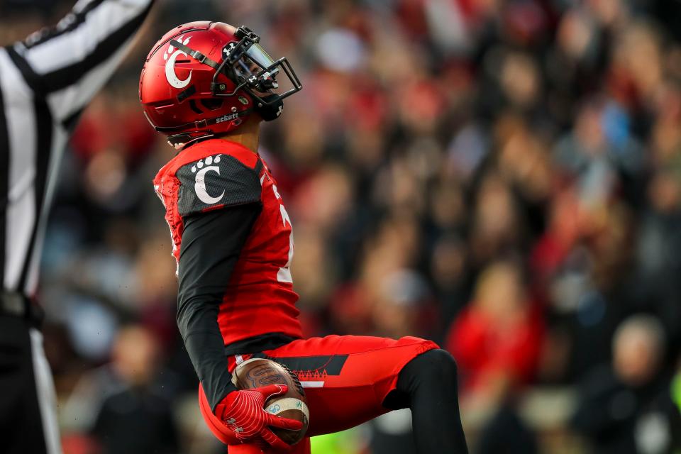 Cincinnati wide receiver Tyler Scott (21), a Norton graduate, reacts after scoring a touchdown during the Bearcats' win over Houston in the American Athletic Conference Championship Game.